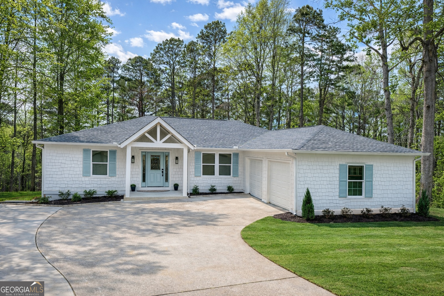 3045 Hitt Road Cumming, GA 30041 - Photo 2 of 46 a front view of a house with a garden