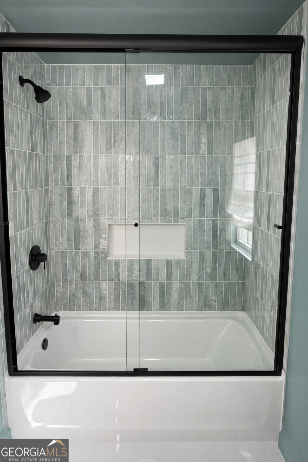 3045 Hitt Road Cumming, GA 30041 - Photo 21 of 46 a bathroom with a bathtub and a shower