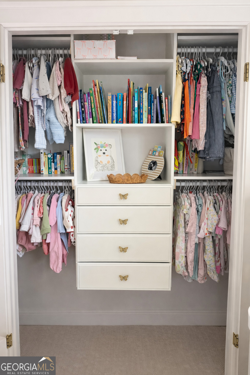 3045 Hitt Road Cumming, GA 30041 - Photo 25 of 46 a view of walk in closet with clothes and shoes