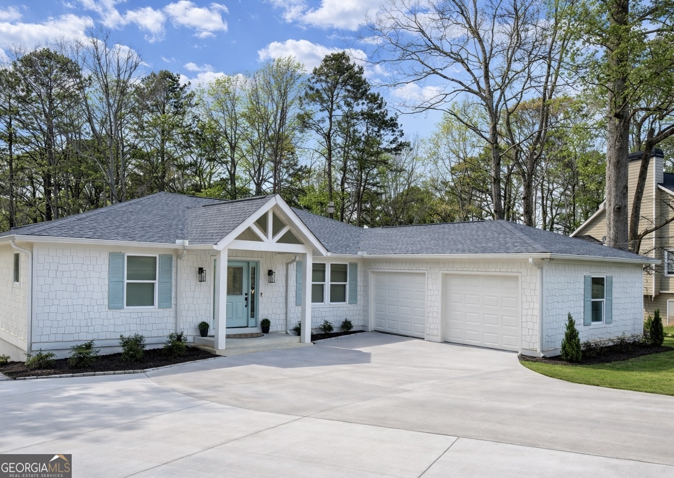 3045 Hitt Road Cumming, GA 30041 - Photo 3 of 46 a front view of a house with a garden