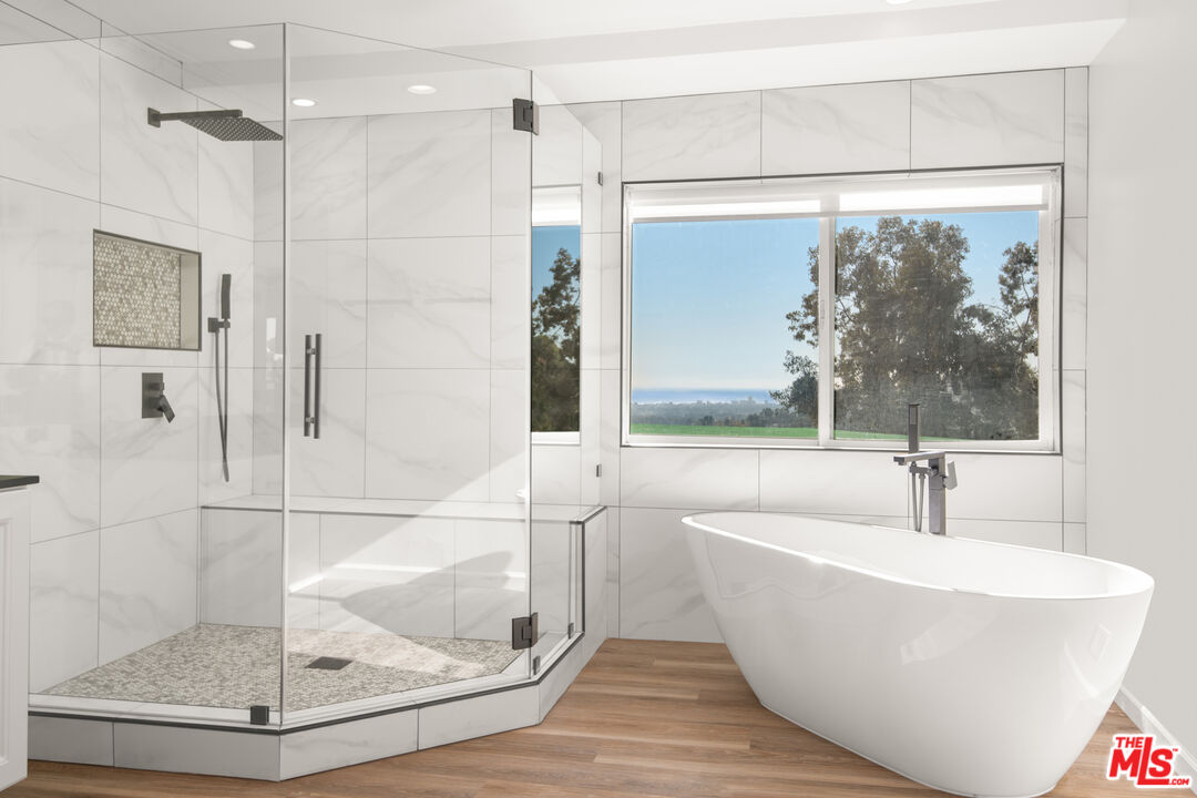 1001 Stradella Road Los Angeles, CA 90077 - Photo 12 of 28 a white bath tub sitting next to a shower