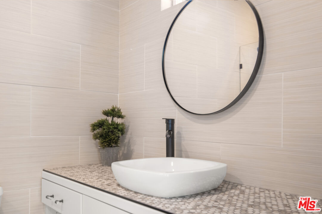 1001 Stradella Road Los Angeles, CA 90077 - Photo 15 of 28 a bathroom with a sink and a mirror