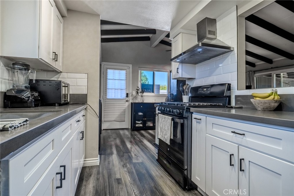 827 South Riverside Avenue Rialto, CA 92376 - Photo 12 of 60 a kitchen with stainless steel appliances granite countertop a stove and cabinets