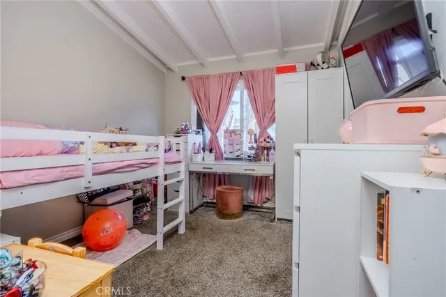 a bedroom with a bed and a desk in it