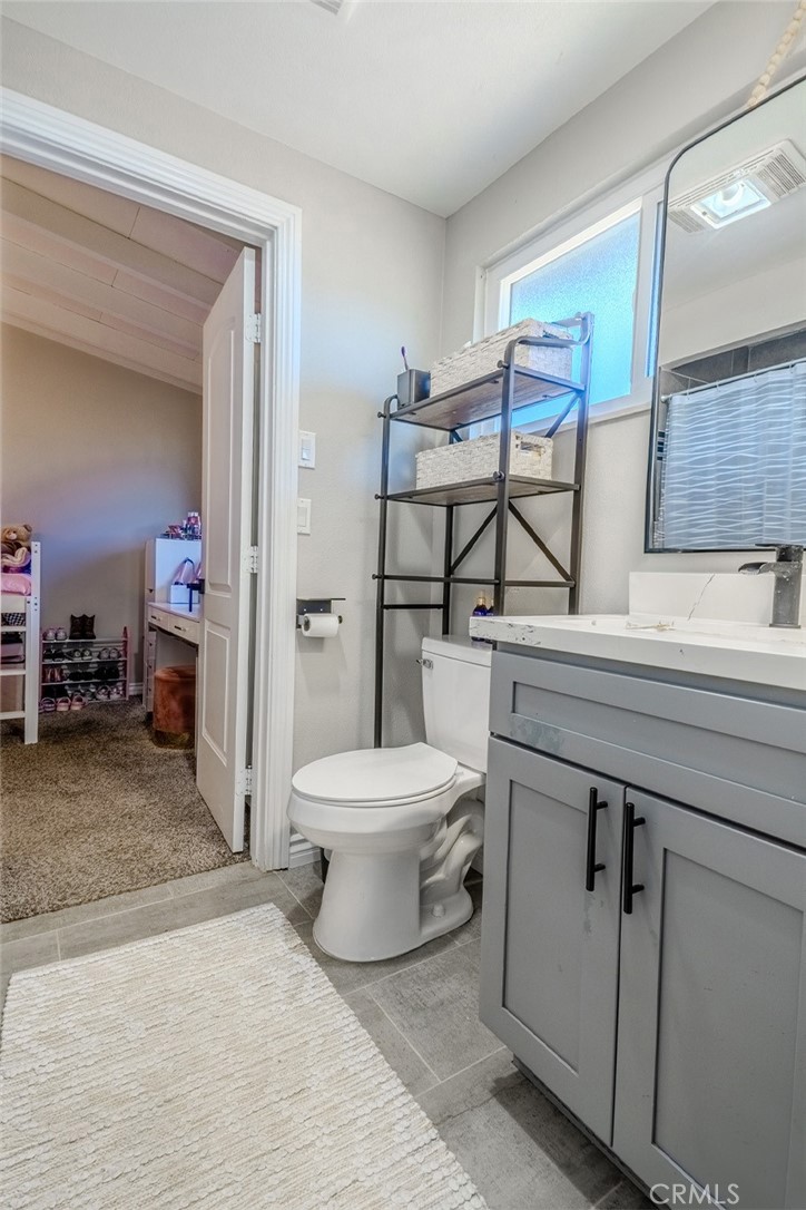 827 South Riverside Avenue Rialto, CA 92376 - Photo 22 of 60 a bathroom with a toilet sink and mirror