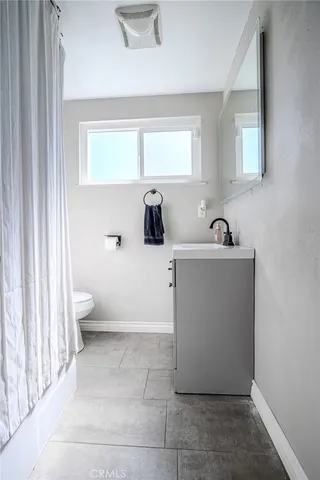 a bedroom with a bed and a desk