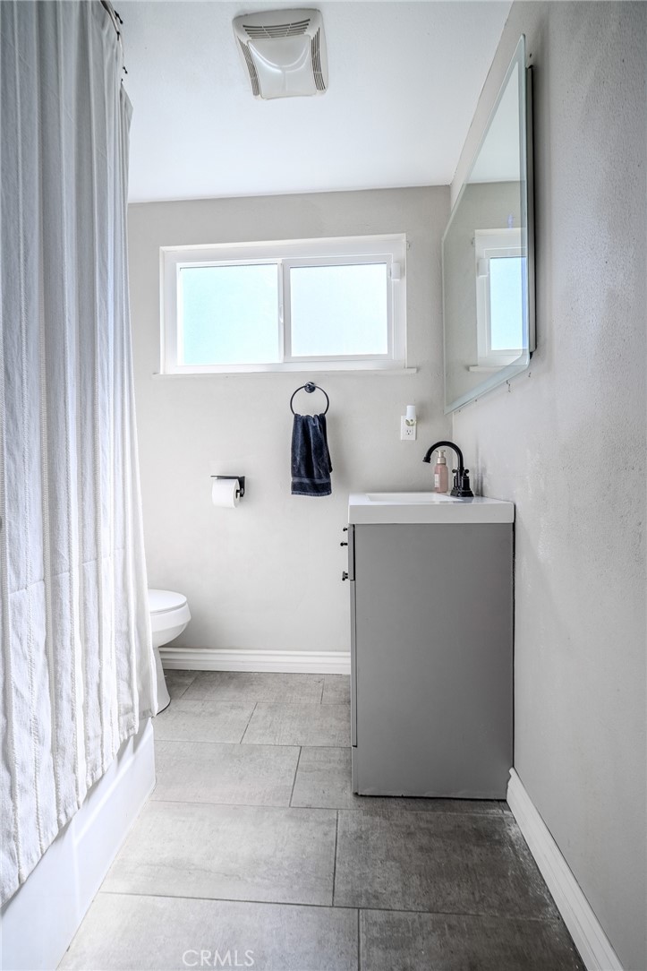 827 South Riverside Avenue Rialto, CA 92376 - Photo 27 of 60 a view of a bathroom with a sink and mirror next to a window