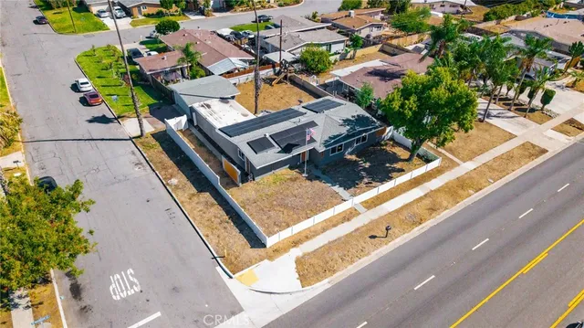 an aerial view of a house with a yard