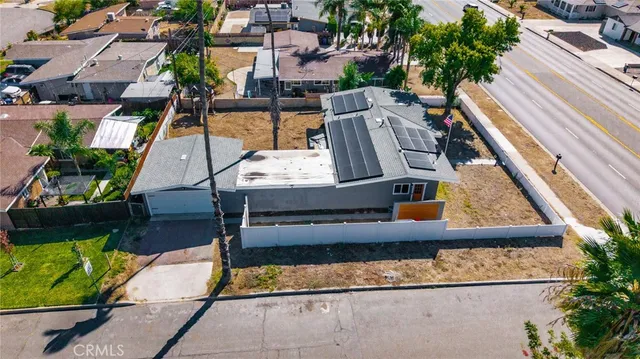 an aerial view of a house with a yard and a large pool