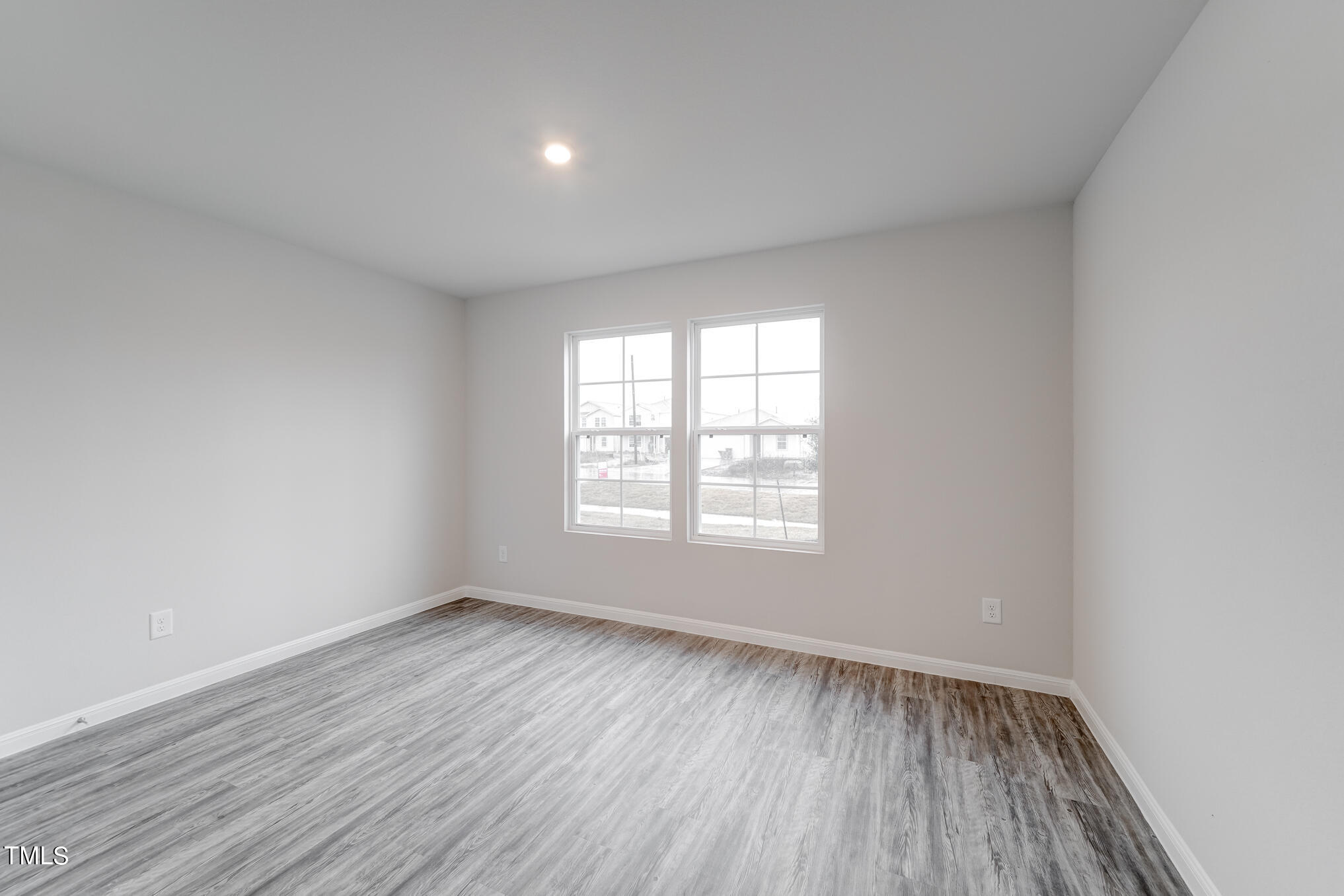 319 Maggie Lane Roxboro, NC 27573 - Photo 13 of 29 an empty room with wooden floor and windows
