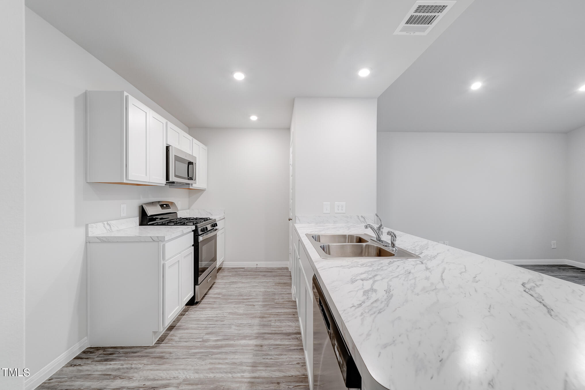 319 Maggie Lane Roxboro, NC 27573 - Photo 7 of 29 a kitchen with sink stove and microwave