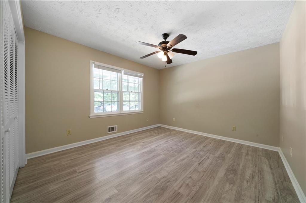 256 Powder Springs Street, Unit A Hiram, GA 30141 - Photo 11 of 16 a view of empty room with wooden floor and fan