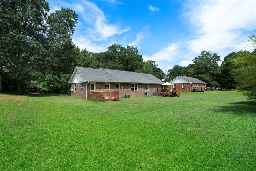 256 Powder Springs Street, Unit A Hiram, GA 30141 - Photo 14 of 16 a front view of a house with garden