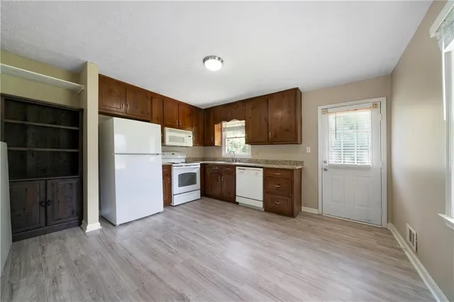 a kitchen with stainless steel appliances a refrigerator and a stove top oven