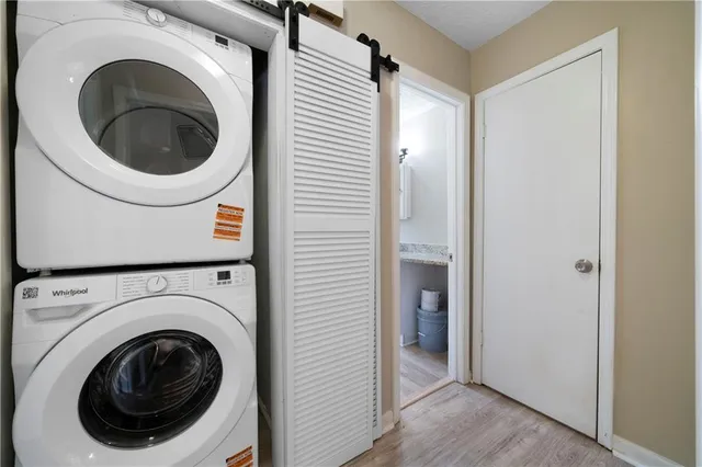 a view of a hallway with washer and dryer