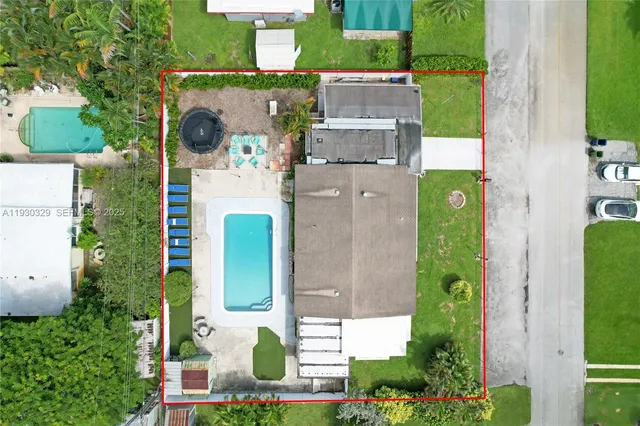 an aerial view of a house with a swimming pool