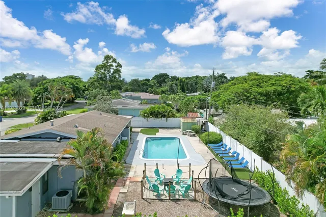 a view of a patio with couches table and chairs and potted plants