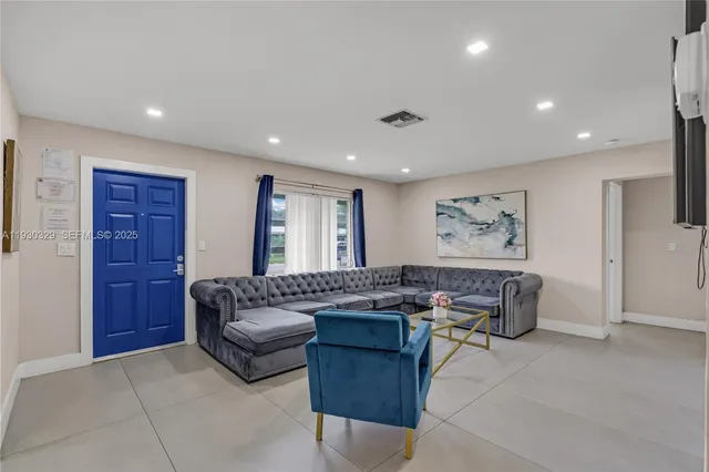 a living room with furniture and a large window