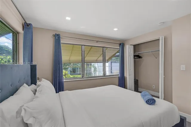 a bedroom with double bed and a large window