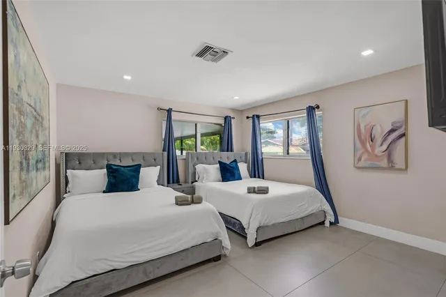 a bedroom with a bed and a painting on the wall