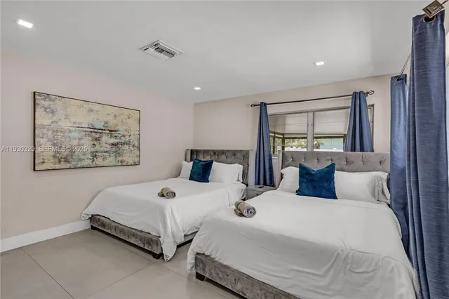 a spacious bedroom with a bed and a couch