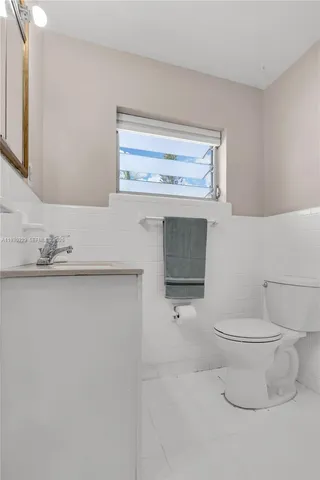 a bedroom with a bed and large windows