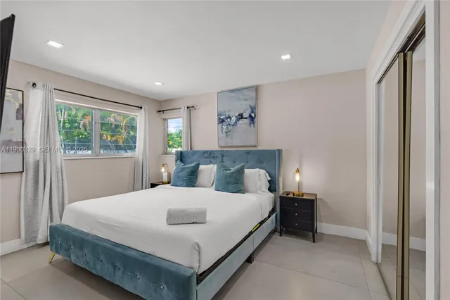 a bedroom with a large bed and a window