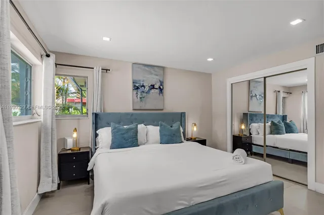 a bedroom with a bed and a couch