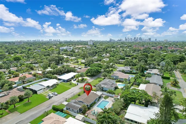 an aerial view of residential houses with outdoor space