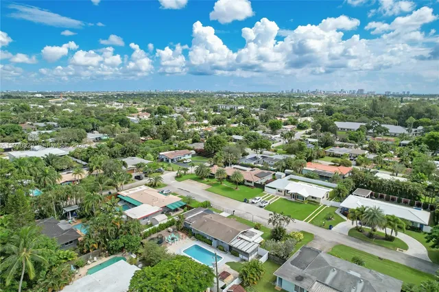 an aerial view of residential houses with outdoor space
