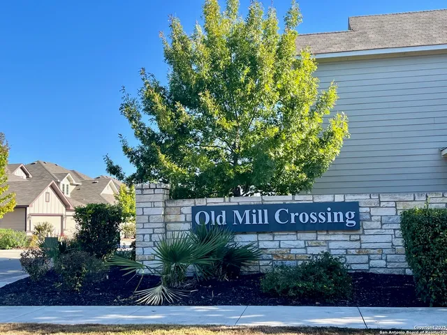 a view of a sign board with potted plants