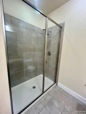 a bathroom with a glass shower door