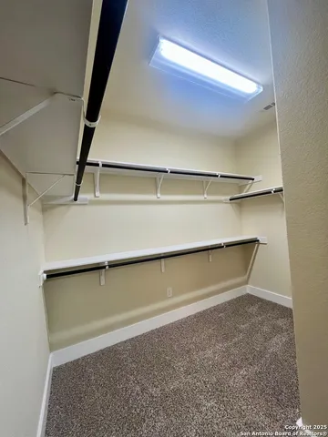 a view of storage and utility room with a window