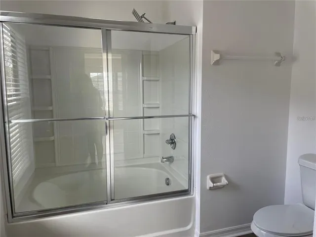 a bathroom with a shower and a toilet