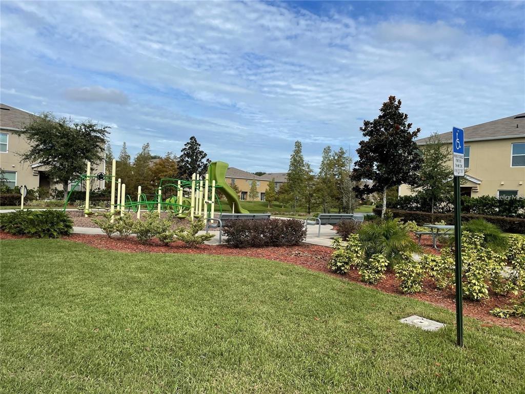 3408 Seneca Club Loop, Unit A Orlando, FL 32808 - Photo 29 of 36 a view of a house with a yard and a garden