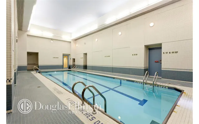a living room with furniture kitchen view and a large window