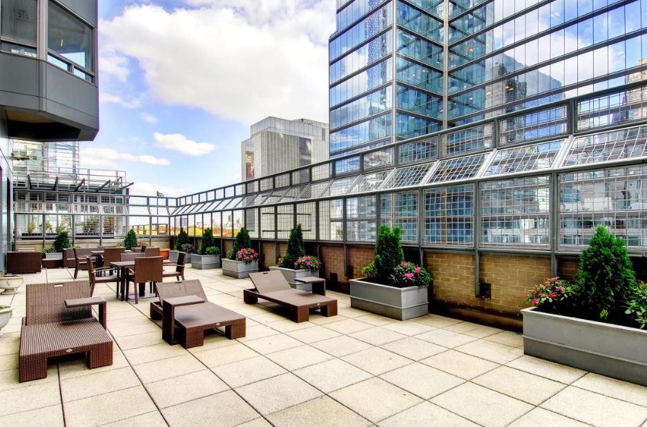 301 West 57th Street, Unit 38B Manhattan, NY 10019 - Photo 16 of 17 a building outdoor space with patio furniture and potted plants