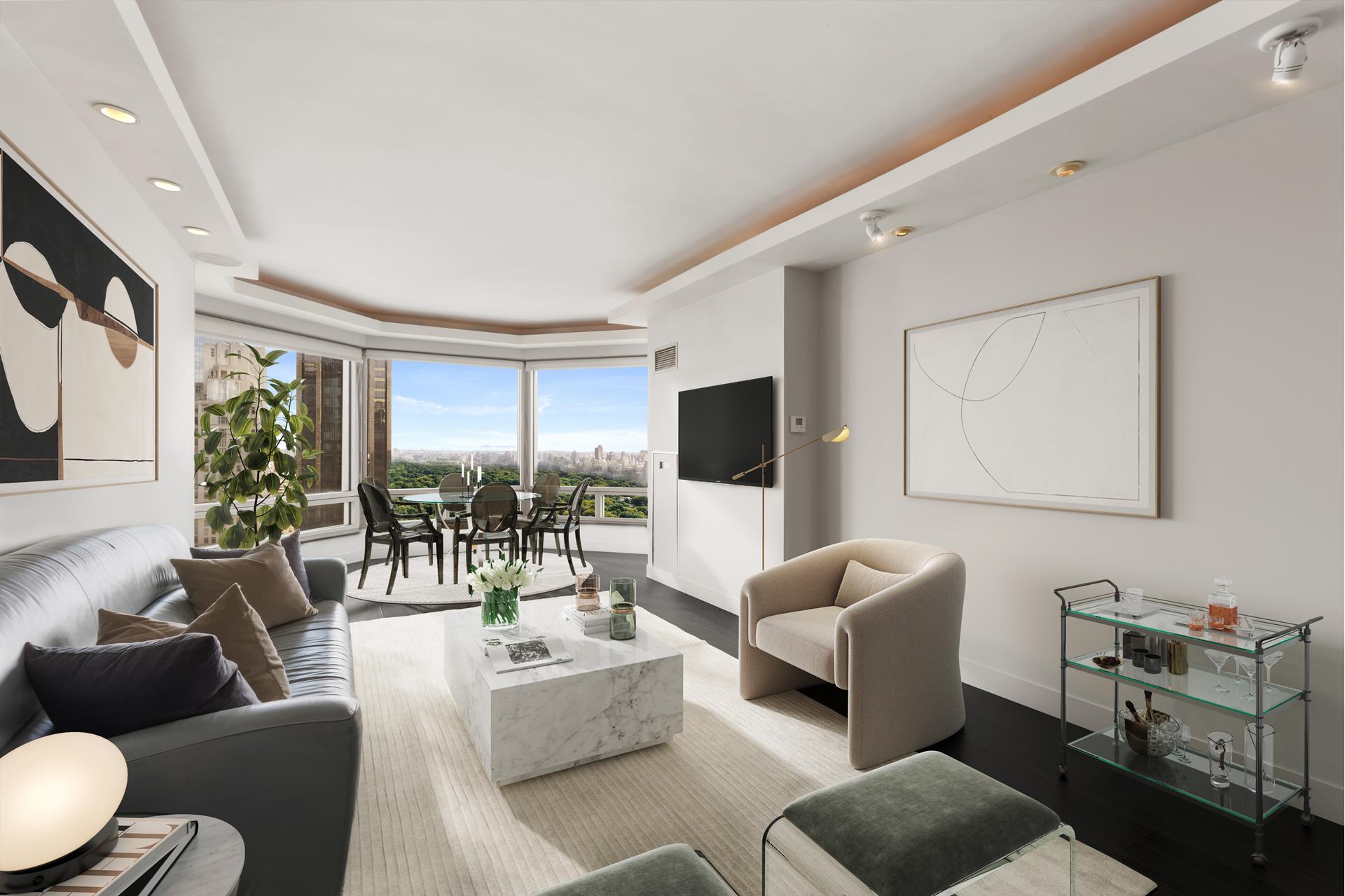 301 West 57th Street, Unit 38B Manhattan, NY 10019 - Photo 4 of 17 a living room with furniture and a flat screen tv