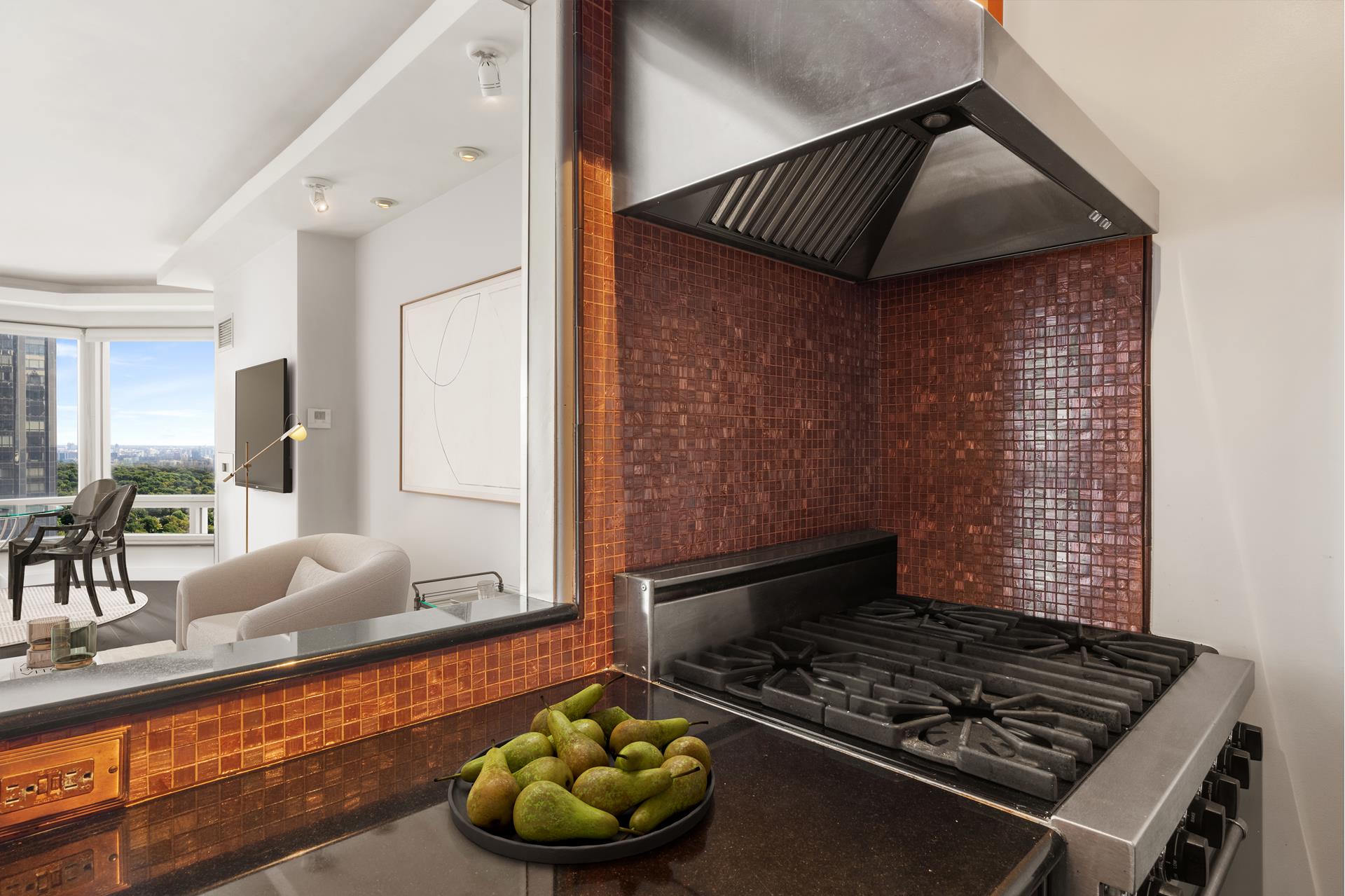 301 West 57th Street, Unit 38B Manhattan, NY 10019 - Photo 5 of 17 a kitchen with wooden cabinets and a stove