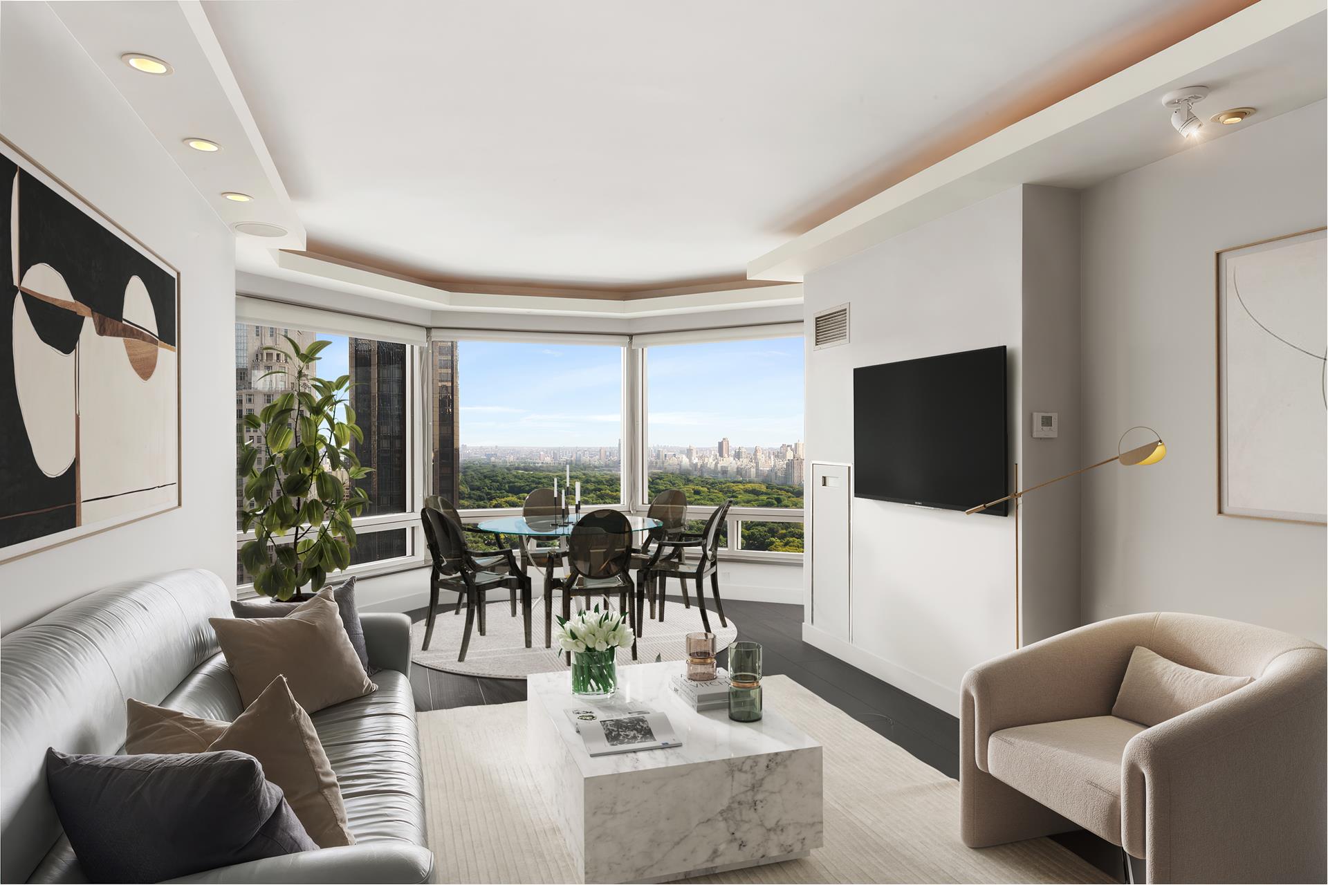 301 West 57th Street, Unit 38B Manhattan, NY 10019 - Photo 7 of 17 a living room with furniture and a flat screen tv