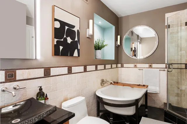 a bedroom with bed and a potted plant