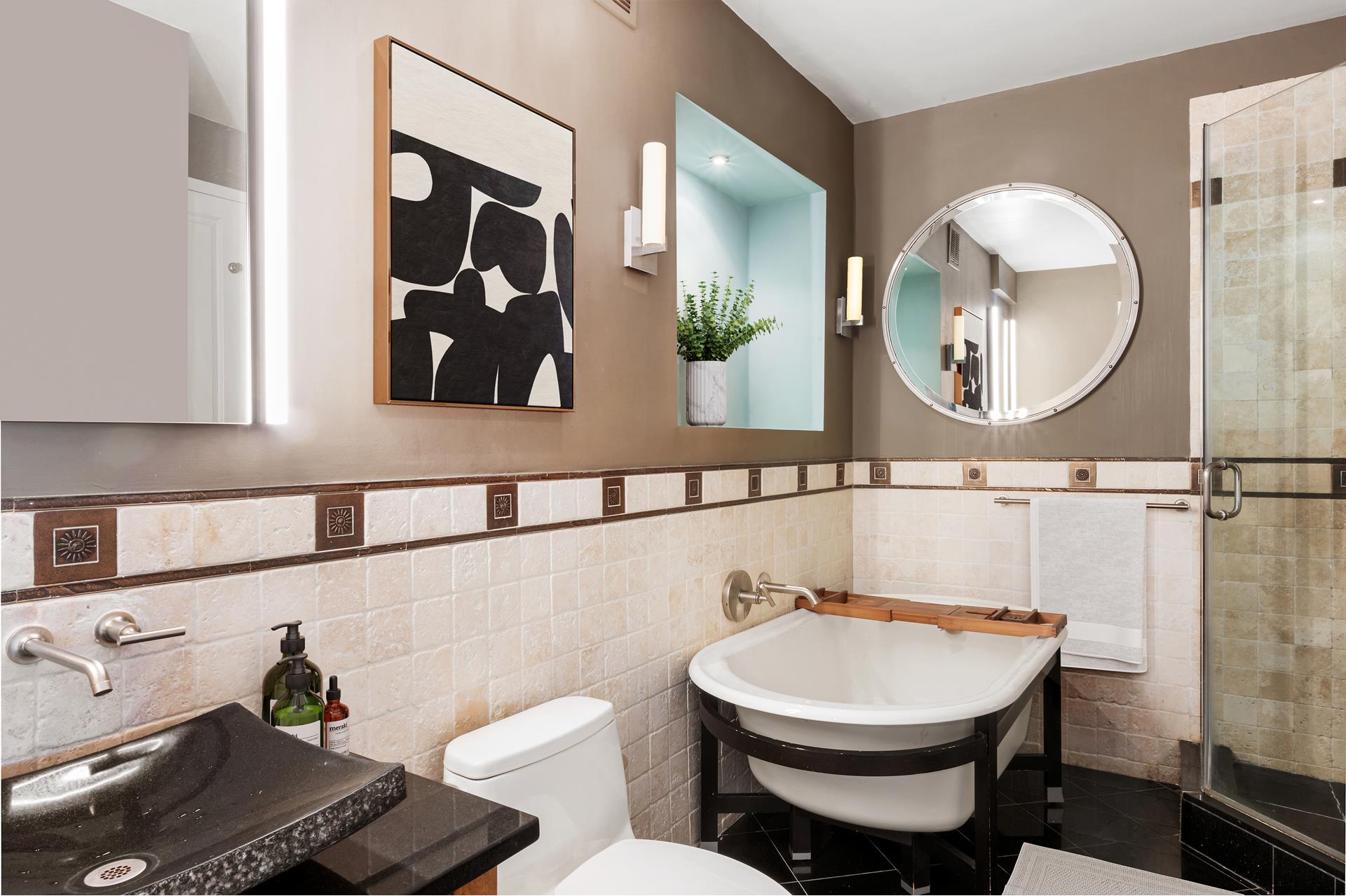 301 West 57th Street, Unit 38B Manhattan, NY 10019 - Photo 9 of 17 a bathroom with a toilet a sink and mirror