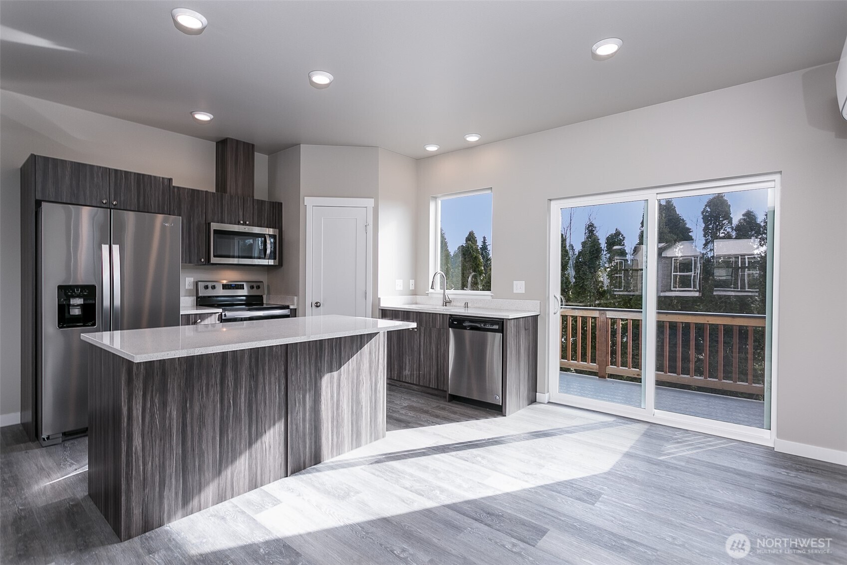 1817 Eastgate Loop Ferndale, WA 98248 - Photo 4 of 32 a kitchen with stainless steel appliances granite countertop a refrigerator a sink a stove a microwave and wooden cabinets