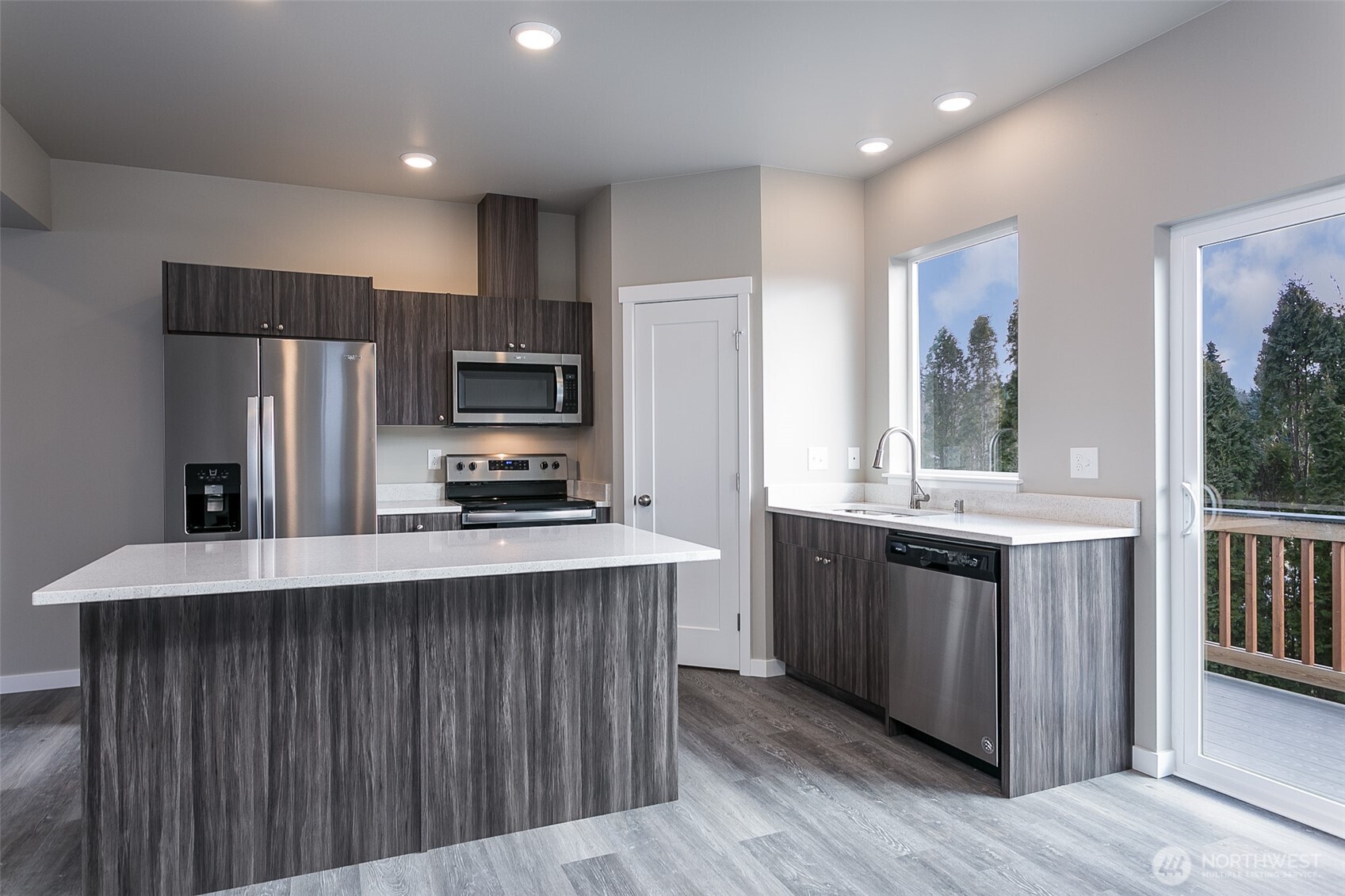 1817 Eastgate Loop Ferndale, WA 98248 - Photo 6 of 32 a kitchen with stainless steel appliances a stove a sink a refrigerator and a center island