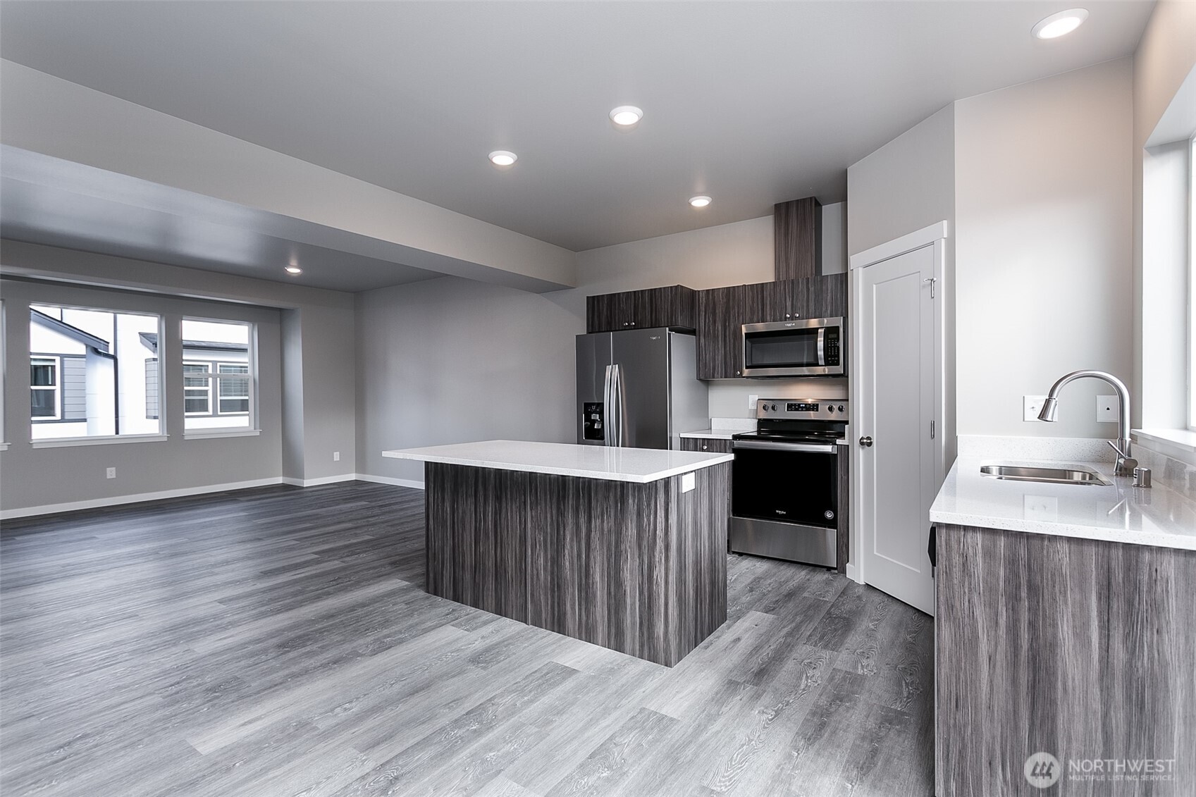 1817 Eastgate Loop Ferndale, WA 98248 - Photo 7 of 32 a kitchen with kitchen island wooden floors appliances and cabinets