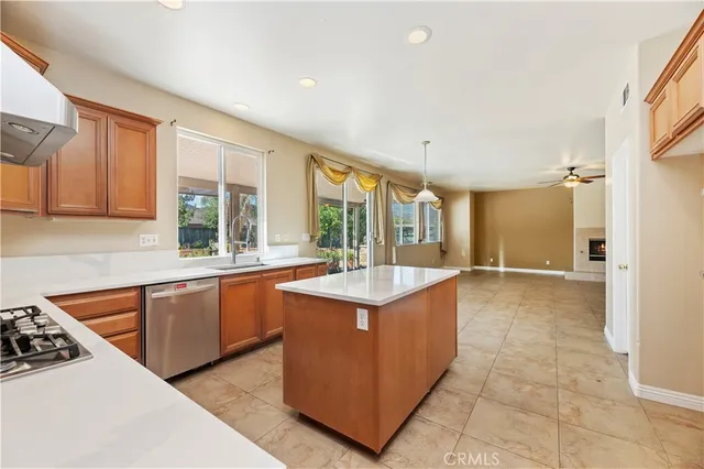 a kitchen with stainless steel appliances granite countertop a sink and a stove