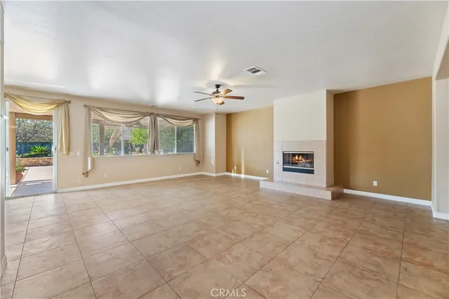 an empty room with windows and chandelier
