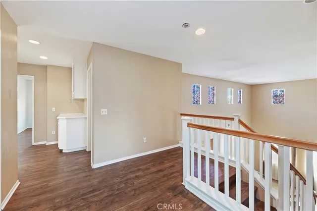 a view of hallway with wooden floor