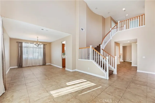 a view of a hallway with entryway and stairs