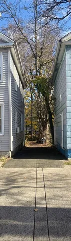 a view of backyard with wooden stairs